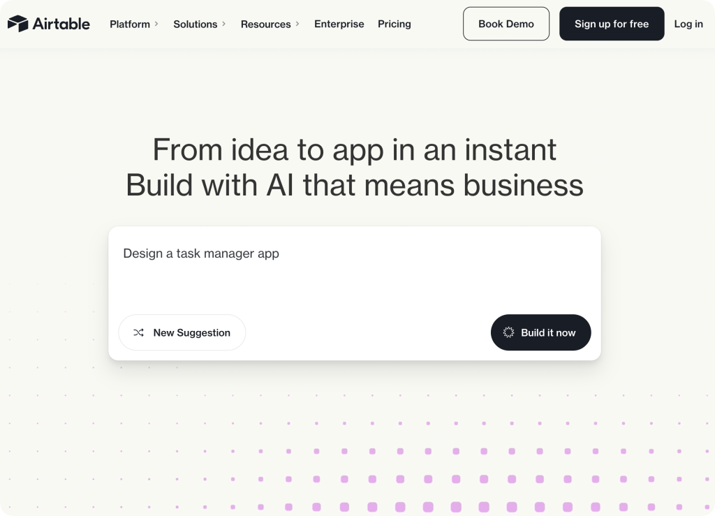 airtable-homepage Airtable homepage with headline “From idea to app in an instant. Build with AI that means business” and a prompt box suggesting “Design a task manager app” with buttons for “New Suggestion” and “Build it now.”