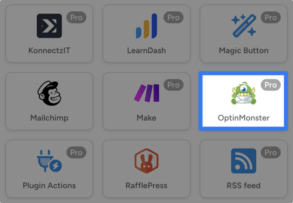 Uncanny Automator integration grid. The OptinMonster integration card is highlighted among other WordPress plugin integrations.