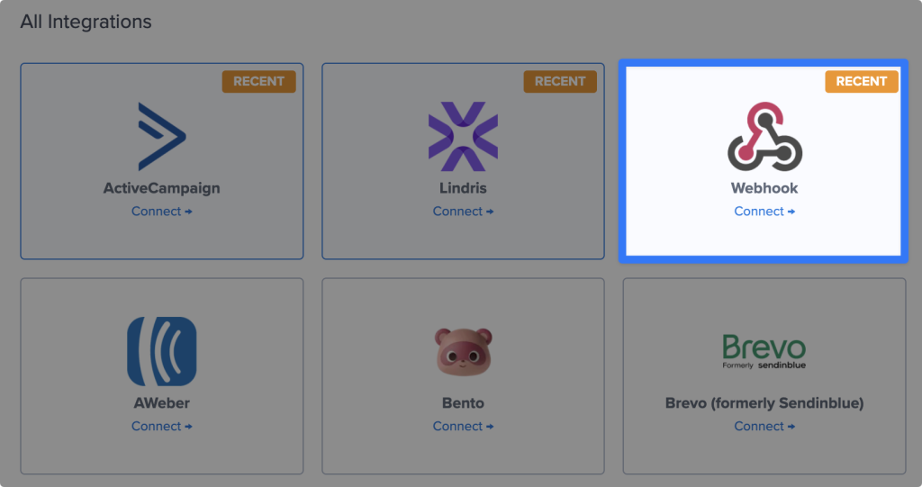 OptinMonster integrations grid. The “Webhook” card is highlighted.